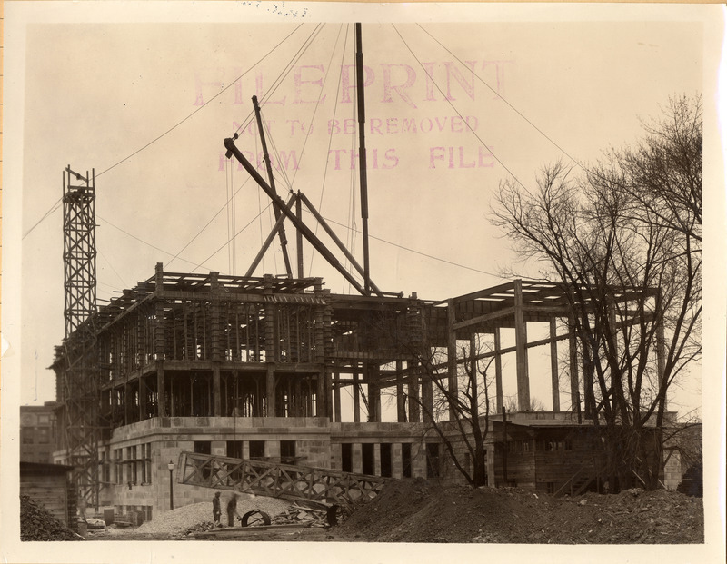 "With funding secured in 1919, it wouldn’t be until 1922 that real movement started on a new fireproof
library building. In September of that year, the Board approved architectural plans by Proudfoot, Bird,
and Rawson, and the next month, the ground was cleared, and excavation started for the foundation.
The following spring, the foundation was poured, and the ironwork for the superstructure began going
up. On October 11, 1923, an informal ceremony was held for the laying of the cornerstone of the
building. Classes were dismissed at 11:30, followed by short speeches by a number of dignitaries, and a
time capsule was placed in the cornerstone."