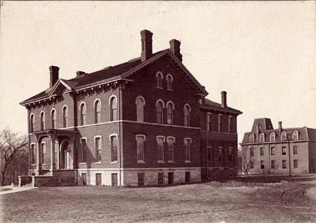 Brick building old photograph with several windows and chimneys