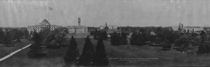 Small dark panoramic view of several buildings and trees