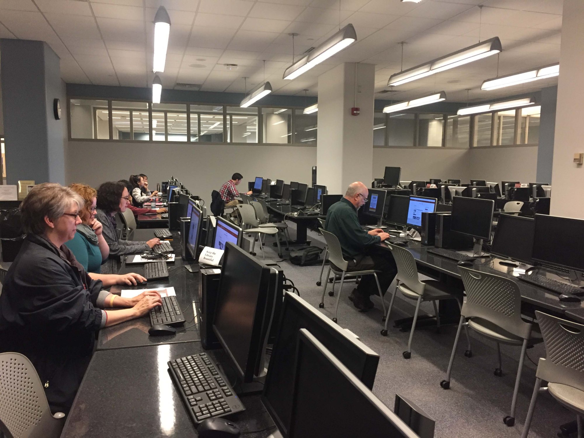 Colored image of people working through the Transcribe-a-thon