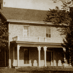 Early photo of the Farm House on the Iowa State University campus in summer.