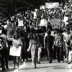 Black and white image protestors marching down Morrill Road near Memorial Union, May 1970
