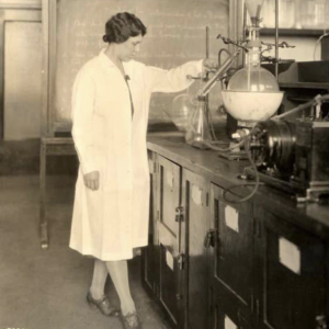 Septic early image of woman nutritionist standing next to lab with large beaker